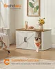 A cat is peeking out of a stylish cat litter box enclosure in a living room setting. Produktbild-Vorschau