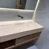 A modern bathroom vanity with a ceramic sink and wooden drawers, illuminated by LED lighting. Anteprima dell’immagine prodotto