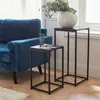 Two black metal side tables are placed next to a blue velvet sofa in a living room setting. Produktbild-Vorschau