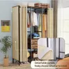 A room with a large open wardrobe, clothes hanging, and storage drawers. Produktbild-Vorschau