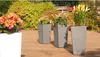 Several planters with flowers on a wooden deck. Náhľad obrázku produktu