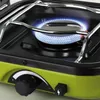 A close-up view of a camping stove with a blue flame burning. Anteprima dell’immagine prodotto