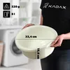 A person is holding a cream-colored plastic basin in front of a washing machine. Voir les images du produit