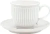 A white ceramic cup and saucer with a ribbed texture and a beaded rim. Voir les images du produit