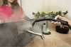 A person is cleaning a bathroom sink faucet with a steam cleaner. Voir les images du produit