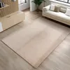 A modern living room with a beige rug, a light-colored sofa, and wooden furniture.