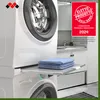 A stacked washing machine and dryer with a pull-out shelf holding folded blue towels. Anteprima dell’immagine prodotto