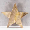 A wooden star decoration against a textured gray background and a white surface. Produktbild-Vorschau