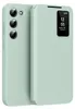 A light green flip case for a Samsung Galaxy S23+ phone, shown from the back and side, with the smart view window displaying the time and date. Náhled obrázku produktu