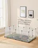 A small animal enclosure with guinea pigs inside, set up in a room with a window and artwork on the wall. Produktbild-Vorschau