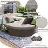 A round rattan garden lounger with cushions by a swimming pool. Podgląd zdjęcia produktu