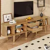 A TV stand with a TV and decorative items in a living room setting. Produktbild-Vorschau