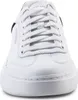 A close-up, front-facing view of a white sneaker with white laces. Náhled obrázku produktu