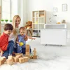 A mother and her two children are playing with wooden blocks on the floor in a bright, modern living room. A white electric heater is visible in the background. Náhľad obrázku produktu