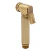 A close-up studio shot of a gold-colored bidet sprayer. Podgląd zdjęcia produktu