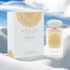 A perfume bottle and its box are displayed on a white, sandy surface with a cloudy sky in the background. Anteprima dell’immagine prodotto