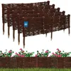 A set of woven willow garden edging with a label attached to one section, and a row of pink flowers and green foliage below. Anteprima dell’immagine prodotto