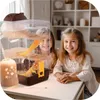 Two young girls smiling at the camera, with a hamster cage in the foreground. Náhľad obrázku produktu