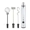 A silver electric milk frother with three interchangeable attachments displayed on a white background. Produktbild-Vorschau