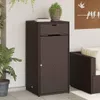 A brown poly rattan garden cabinet with a drawer and a door, placed on a patio next to a plant and an armchair. Podgląd zdjęcia produktu