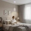 A woman is reading a book in bed in a bedroom, with a pendant light hanging above. Náhled obrázku produktu