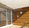 A ceiling-mounted clothes drying rack with multiple rods, installed on a balcony or patio with wooden siding and a glass door. Produktbild-Vorschau