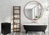 A bathroom scene featuring a black clawfoot bathtub, a wooden ladder shelf, and a black laundry basket. Voir les images du produit