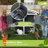 Two children interacting with a two-story rabbit hutch outdoors. Produktbild-Vorschau