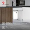 A white under-sink water heater is shown with cabinet doors open, next to kitchen cabinets and a faucet. Anteprima dell’immagine prodotto
