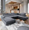 A modern living room with a large sectional sofa, coffee tables, and a kitchen area in the background. Produktbild-Vorschau