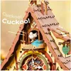 A close-up view of a wooden 3D puzzle cuckoo clock, with a white bird emerging from its opening. Náhľad obrázku produktu