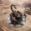 A mechanical scorpion model is displayed on a circular platform in a desert-like environment. Náhled obrázku produktu