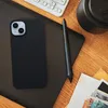 A flat lay of a smartphone case, stylus, keyboard, and some cash on a wooden desk. Náhled obrázku produktu