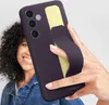 A person is holding a smartphone with a dark violet case and a yellow grip. Produktbild-Vorschau