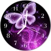 A round wall clock with a purple butterfly design and sparkling stars. Produktbild-Vorschau