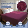 A bed with a burgundy fitted sheet and white pillows, with marketing text and material composition details. Produktbild-Vorschau