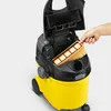 A hand is placing a filter into a Karcher vacuum cleaner. The vacuum is yellow and black. Náhľad obrázku produktu