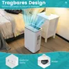 A white air purifier is shown in a bedroom setting next to a nightstand and bed, with blue air flow graphics emanating from the top. Produktbild-Vorschau