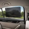 A sunshade is attached to the inside of a car window, with trees and a road visible outside. Náhľad obrázku produktu
