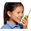 A young girl is holding a toy walkie-talkie to her ear and smiling. Voir les images du produit