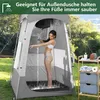 A woman is showering inside a portable outdoor shower tent. A shelf unit with toiletries is next to the tent. Produktbild-Vorschau