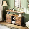 A vintage-style buffet with drawers and shelves, decorated with items like records, a turntable, and flowers, in a room with green walls and a floor lamp. Podgląd zdjęcia produktu