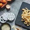 A flat lay of ingredients and tools for making homemade pasta, including eggs, flour, pasta cutters, and freshly made pasta. Produktbild-Vorschau
