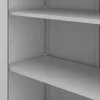 Close-up view of the interior of a gray metal office cabinet with shelves. Voir les images du produit