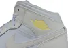 A close-up view of a white and light gray Nike Air Jordan 1 Mid sneaker, featuring a yellow Air Jordan logo. Podgląd zdjęcia produktu