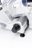 A close-up view of a meat slicer's control knob and part of the blade guard. Náhľad obrázku produktu