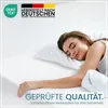 A woman sleeping peacefully on a mattress. Produktbild-Vorschau