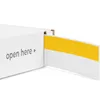 A white box with yellow trim, partially opened, with the text 'open here' visible. Anteprima dell’immagine prodotto