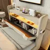 A modern bed with an open headboard revealing storage compartments and integrated lighting. Produktbild-Vorschau