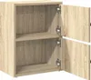 A light brown wooden cabinet with two doors, one slightly ajar, revealing two shelves inside. The cabinet has a wood grain texture. Náhled obrázku produktu